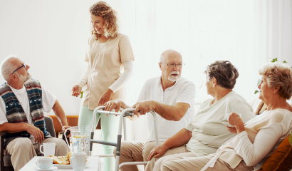 group of elderly and their caregiver