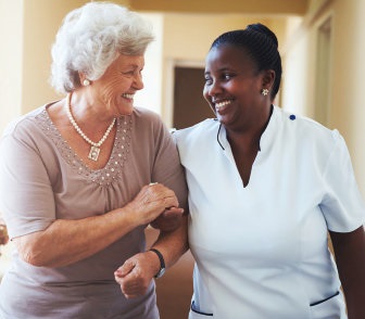 senior woman walking with her caregiver