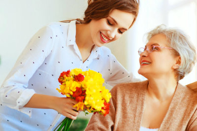 woman give flowers of the grandma